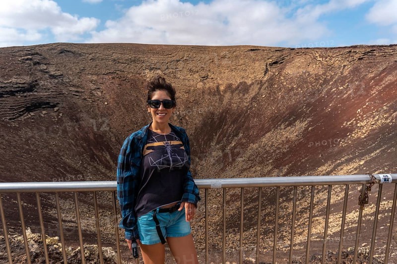 A young tourist visiting the Crater of the Calderon Hondo volcano near Corralejo