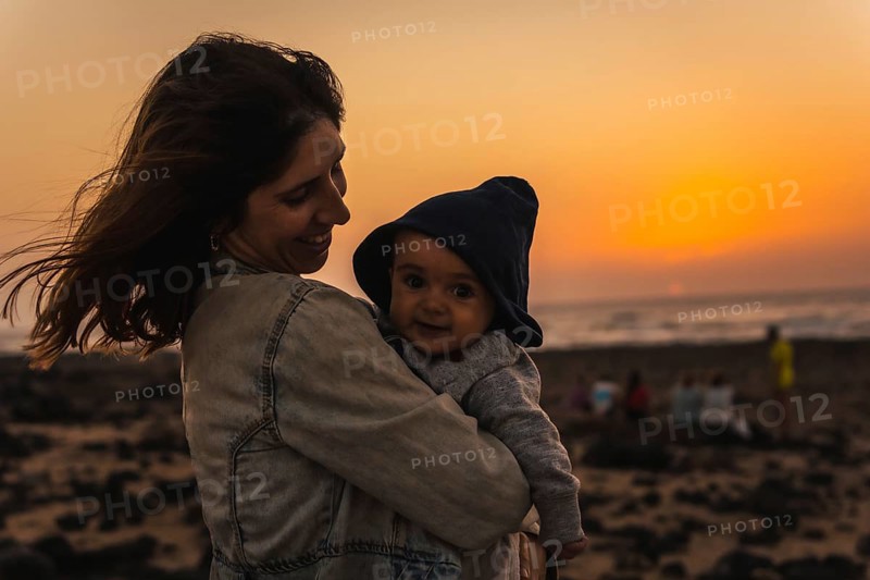A young mother with her son at the Toston Lighthouse Sunset
