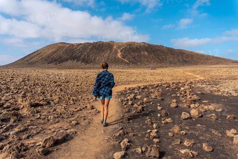 A young woman on the trail to the Crater of the Calderon Hondo volcano near Corralejo