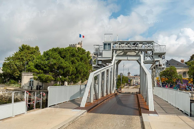 A bridge in the marina next to the towers of the fort in La Rochelle. Eastern france