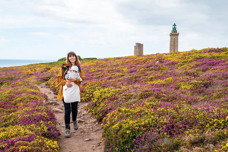 A mother next to the flowers in summer in Phare Du Cap Frehel