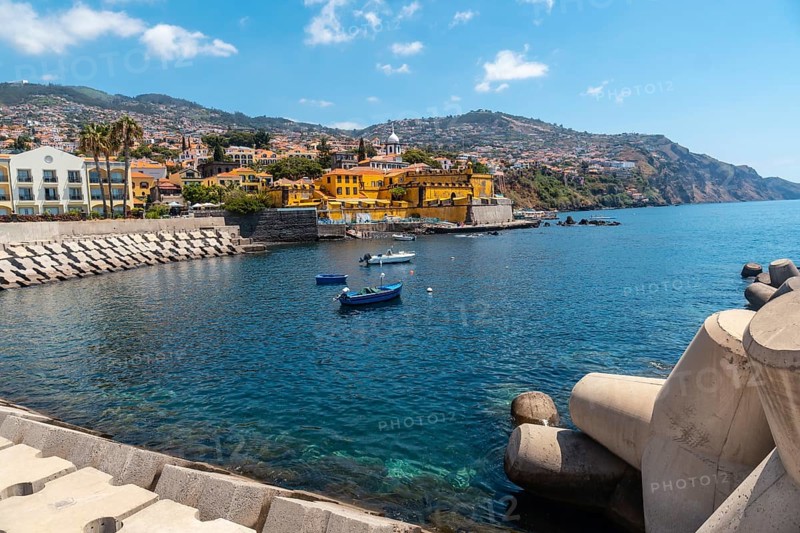 Small fishing boats next to the Forte de Sao Tiago on the beach of Funchal