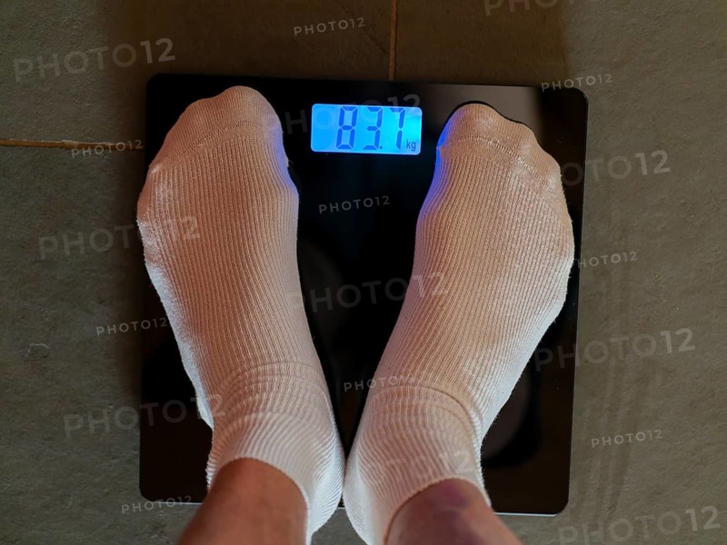 Feet with white socks on personal scale