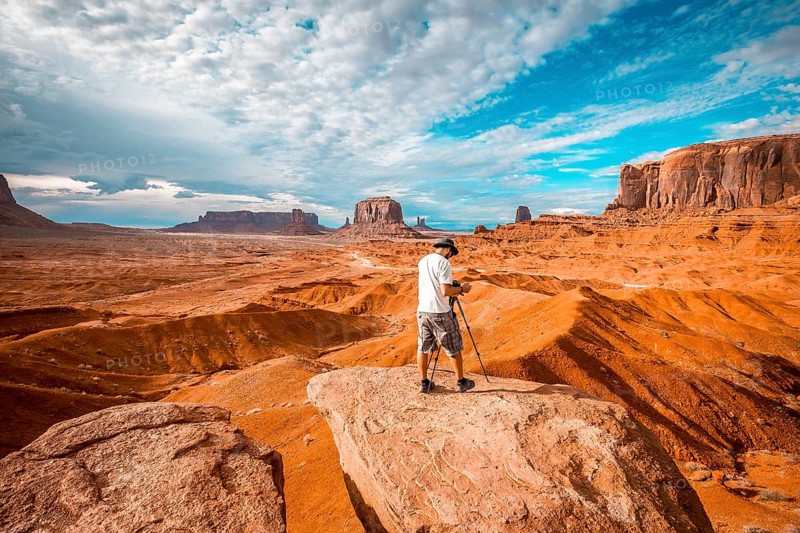 A European photographer at John Ford's Point in Monument Valley preparing a panor. Utah