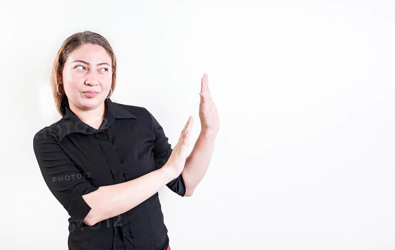 Displeased young woman rejecting with palms hands isolated. Disgusted young woman with rejection gesture. He frowns in disgust