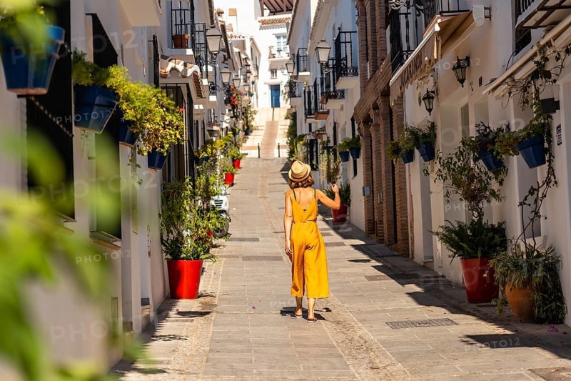 A tourist in Mijas visiting the white houses and charming town and the slopes in Malaga. Andalusia