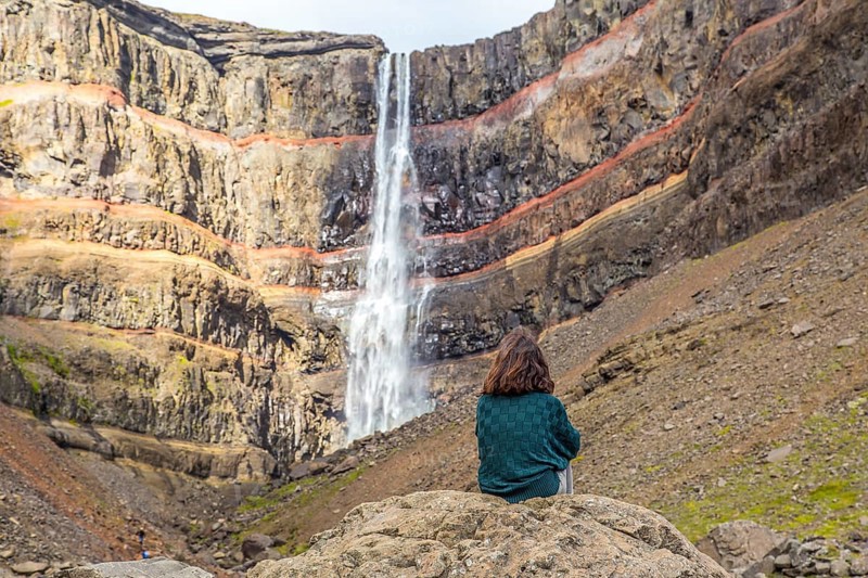 A young girl sitting in one of the wonders of Iceland