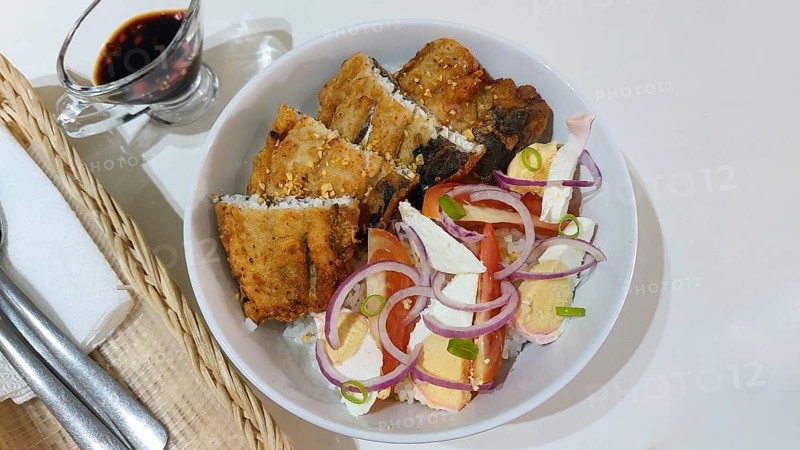 Authentic traditional Filipino breakfast of fried bangus or milkfish with tomato and salted duck egg salad from Philippines