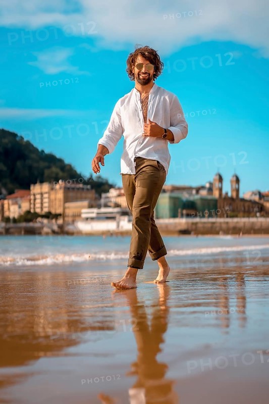Summer lifestyle with a young dark-haired Caucasian man with long beard