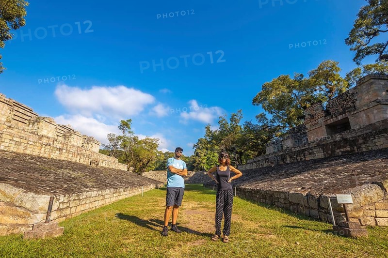 A couple strolling through the ball game in the temples of Copan Ruinas. Honduras