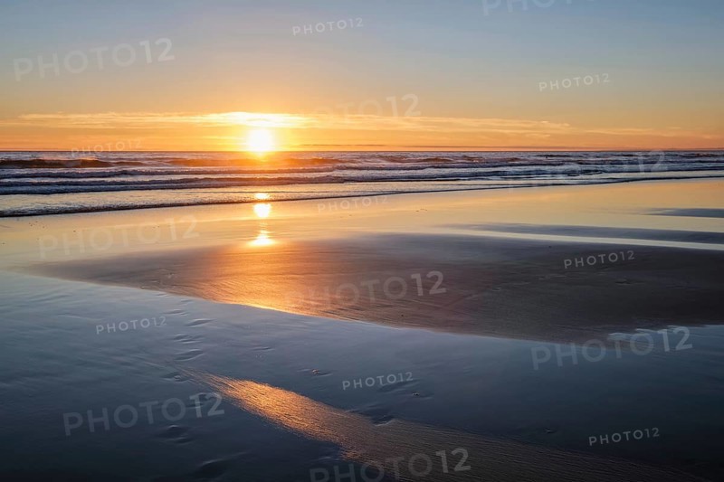 Atlantic ocean sunset with surging waves at Fonte da Telha beach
