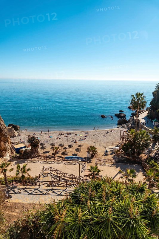 Calahonda beach in the town of Nerja with people sunbathing in spring