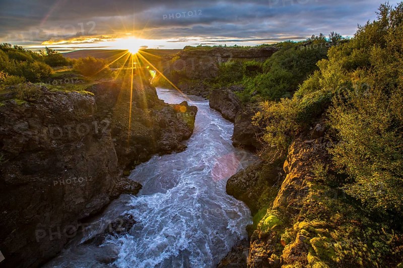 Gorgeous sunset on the wooden bridge of the Barnafoss river