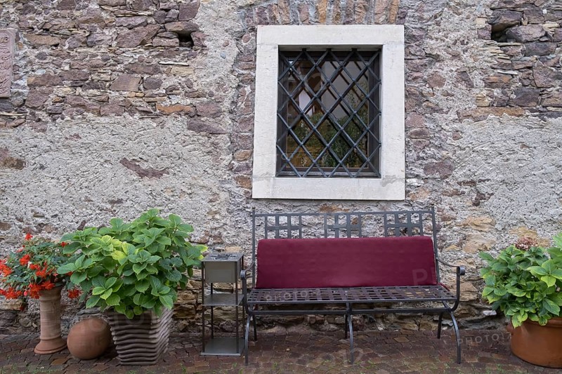 Bench in front of an old house made of quarry stones