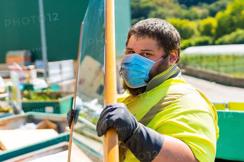 Worker in a recycling factory or clean point and garbage with a face mask and with security protections
