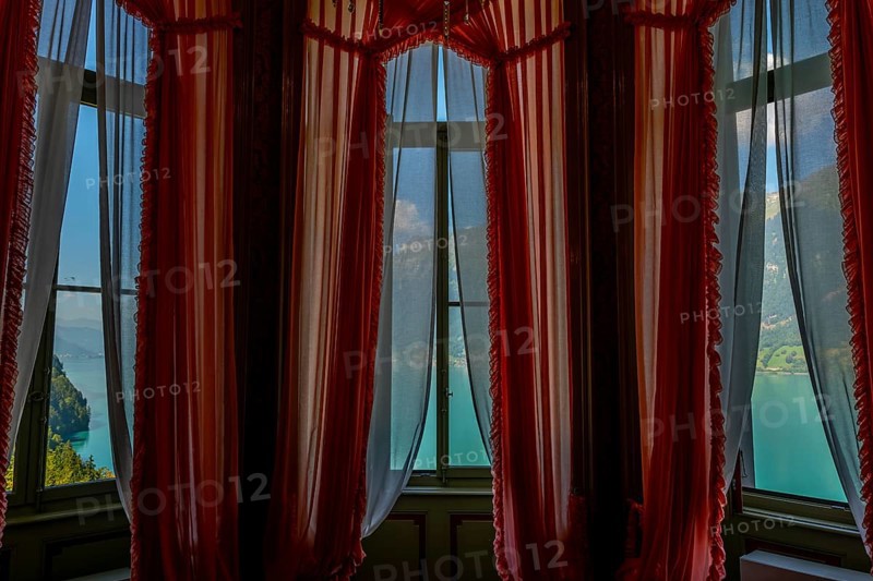 Window View from The Historical Grandhotel Giessbach with View over Mountain and Lake Brienz with Sunlight in Bernese Oberland