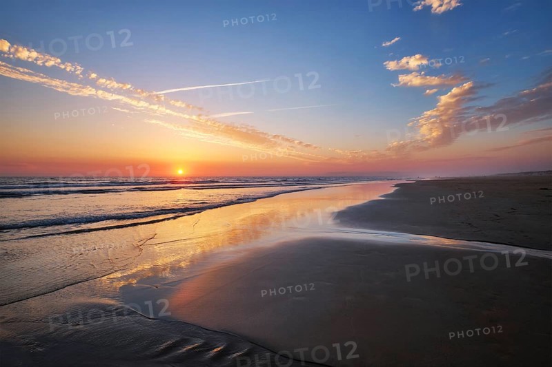 Atlantic ocean sunset with surging waves at Fonte da Telha beach
