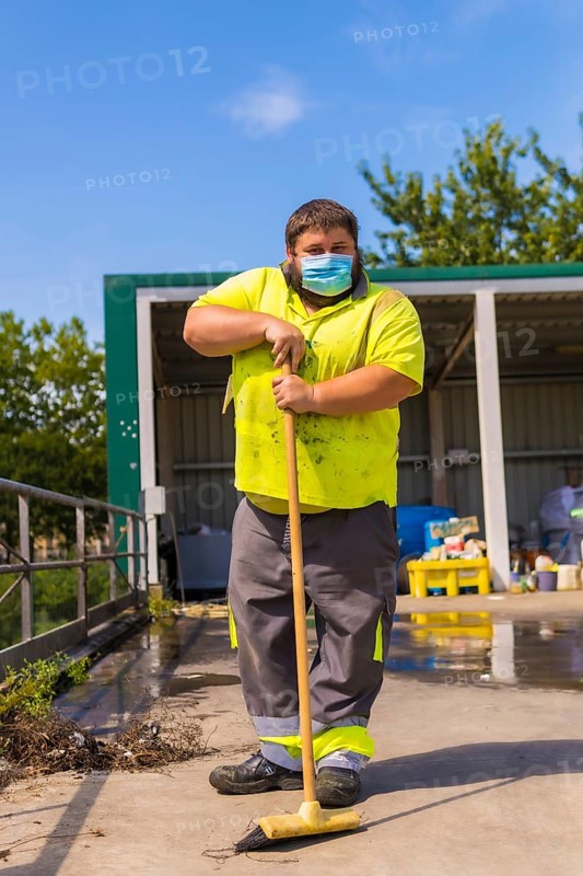 Worker in a recycling factory or clean point and garbage with a face mask and with security protections