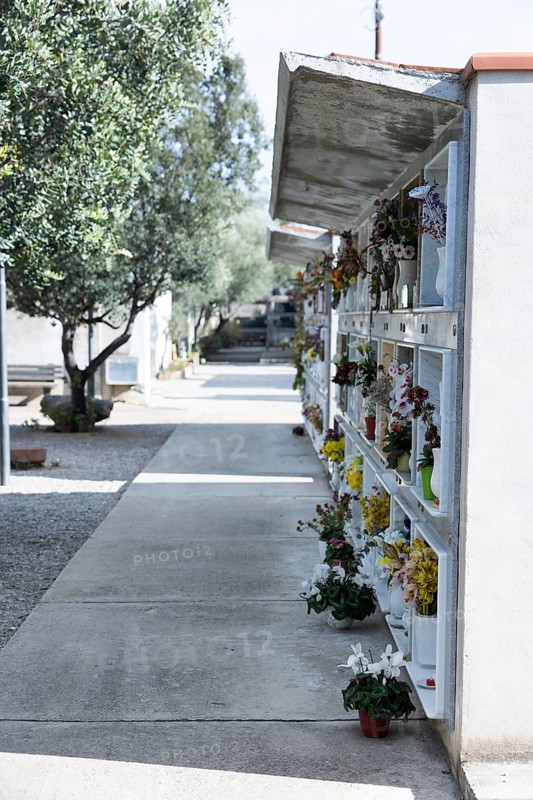 Wall with decorated urns graves in a cemetery in Sardinia