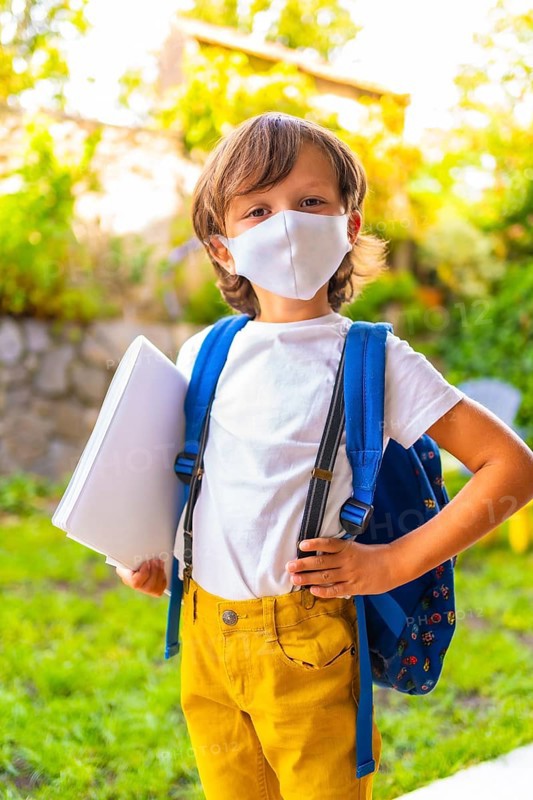 Caucasian child with face mask ready for back to school. New normality