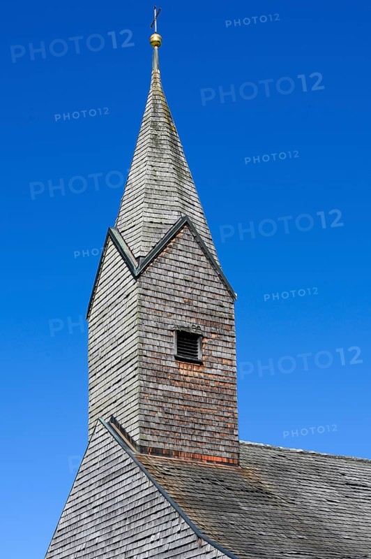 Tower of the Chapel of St. Nicholas and St. Magdalene with many wooden shingles in Linsen near Niedersonthofen