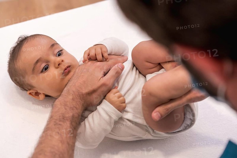 High angle view and close-up of a cute baby during an examination with the doctor