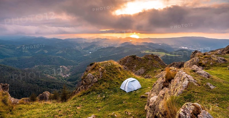 Wild camping on the top of a mountain at sunset