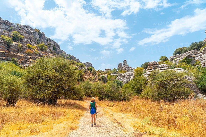 A young woman trekking in the Torcal de Antequera on the green and yellow trail