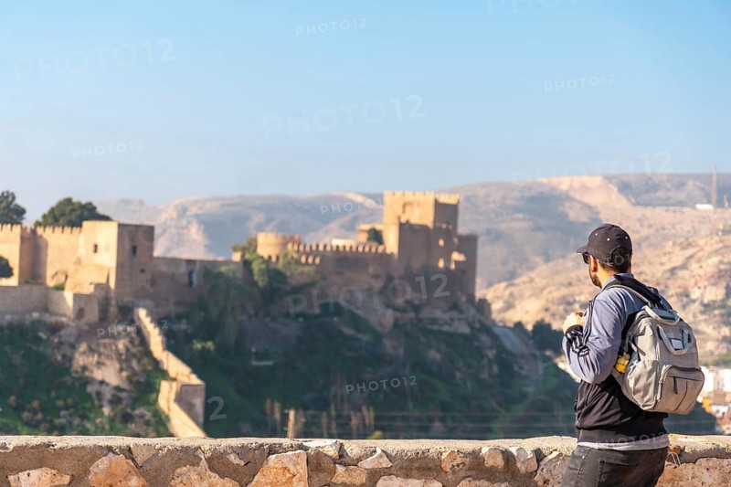 A young tourist at the viewpoint of Cerro San Cristobal de la Muralla de Jairan and the Alcazaba the town of Almeria