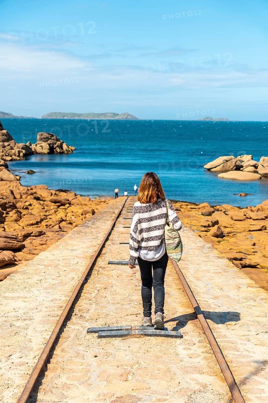 A young woman on the way to descend the boats next to the Mean Ruz Lighthouse