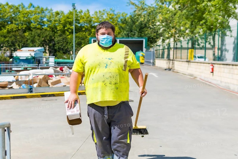 Worker in a recycling factory or clean point and garbage with a face mask and with security protections