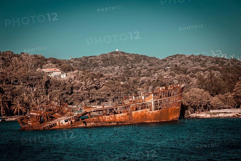 Boat with abandoned rock in the port of Roatan. Honduras