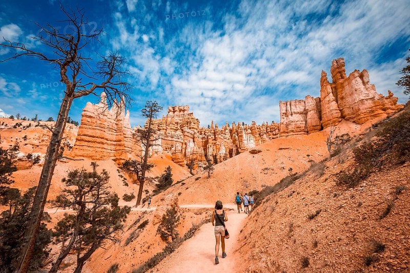 A young woman walking along the giant eroded stones on the Queens Garden Trail
