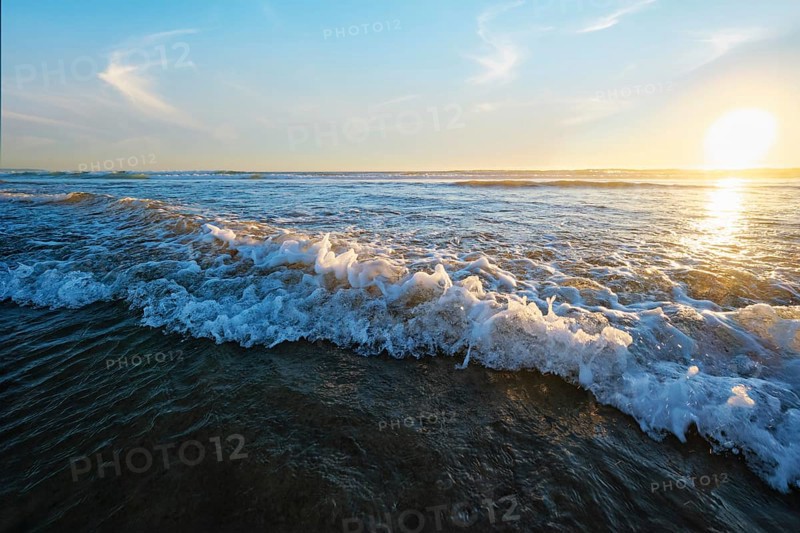 Atlantic ocean sunset with surging waves at Fonte da Telha beach