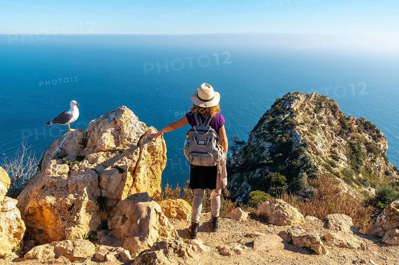 A young hiker at the Mirador de Carabineros in the Penon de Ifach Natural Park in the city of Calpe