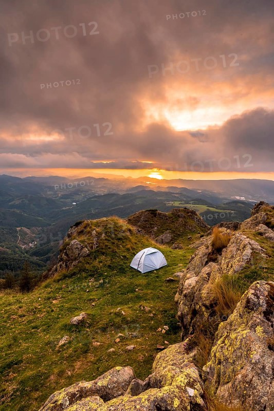 Wild camping on the top of a mountain at sunset