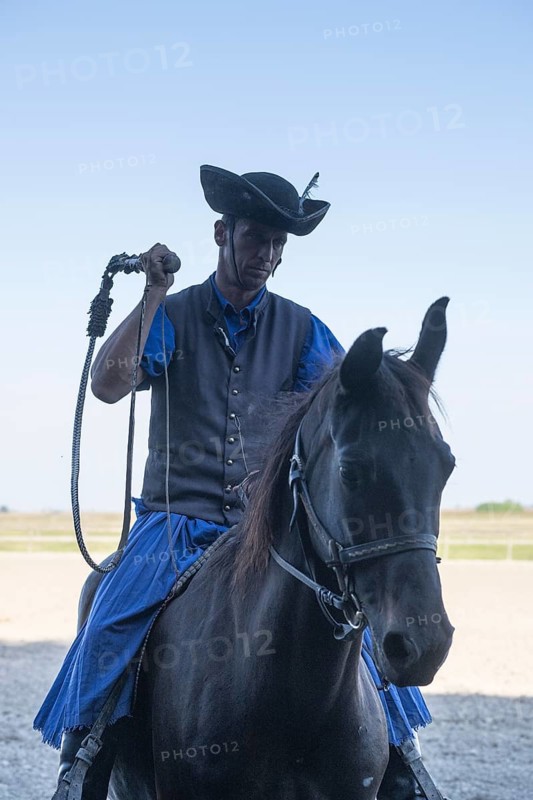 Cracking the whip with the Hungarian shepherd's whip on horseback