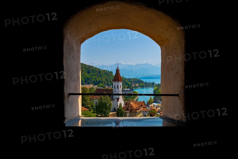Window View over City of Thun and Lake Thun with Mountain and a Church in a Sunny Day in Thun