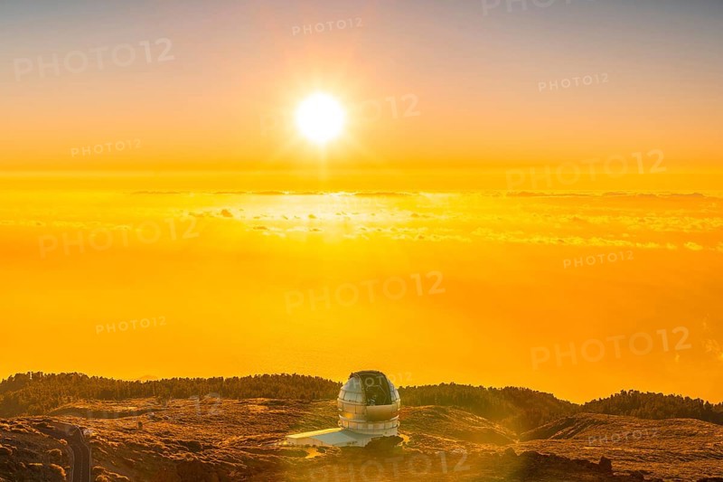 Large Canary Telescope called Grantecan optico del Roque de los Muchachos in the Caldera de Taburiente in a beautiful orange sunset