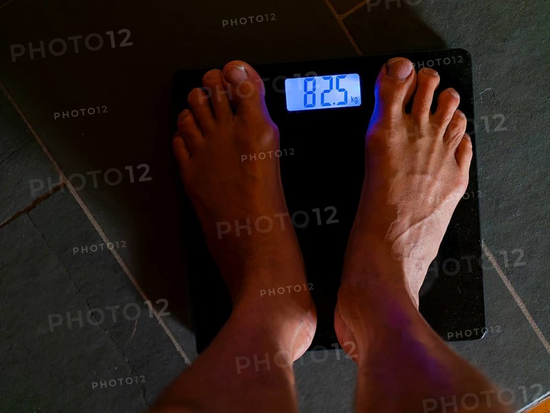 Men's feet on personal scale