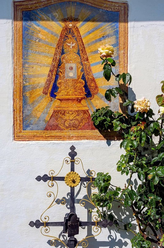 Christian fresco and iron burial cross with rose bush in the Swabian Open Air Museum