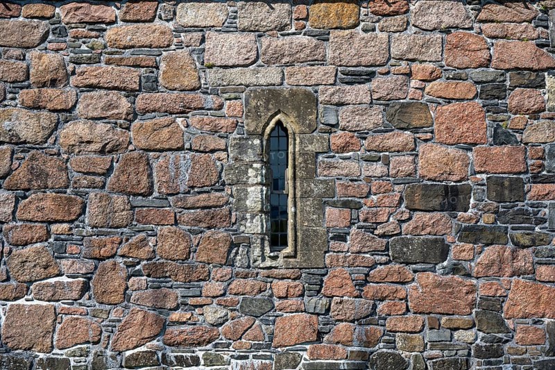 Ross of Mull granite and basalt house wall with a narrow window