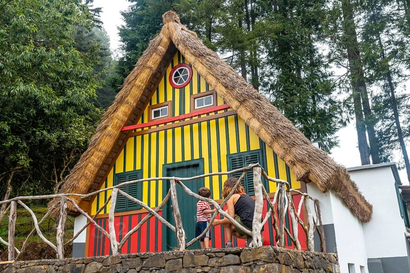 Mother and son in a Madeiran house like those of Santana in the forest of Caldeirao Verde