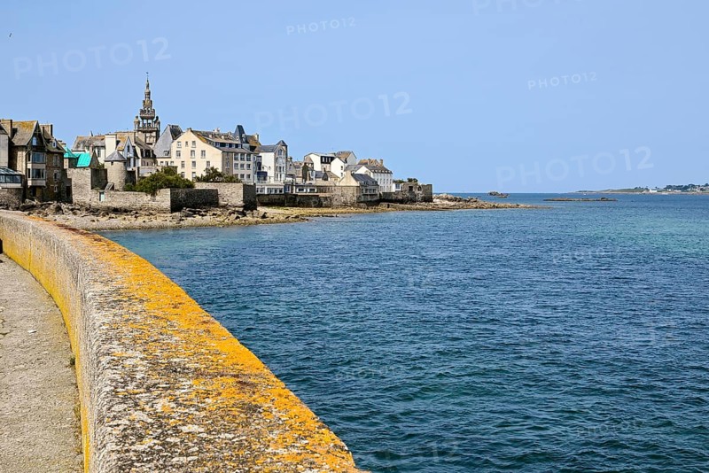 Old town with buildings and church tower by the sea