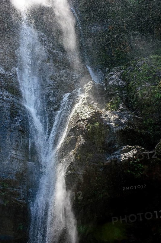Water splashing against rocks in sunlit waterfall in Minas Gerais