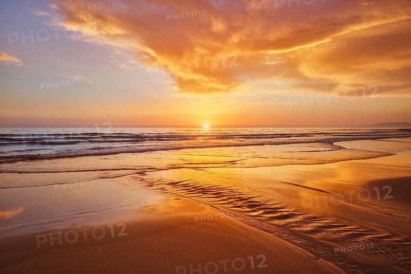 Atlantic ocean sunset with surging waves at Fonte da Telha beach