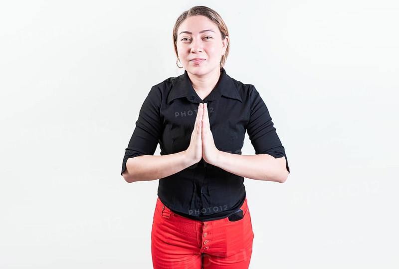 Attractive young woman asking for a favor isolated. Latin girl asking for help with her hands isolated