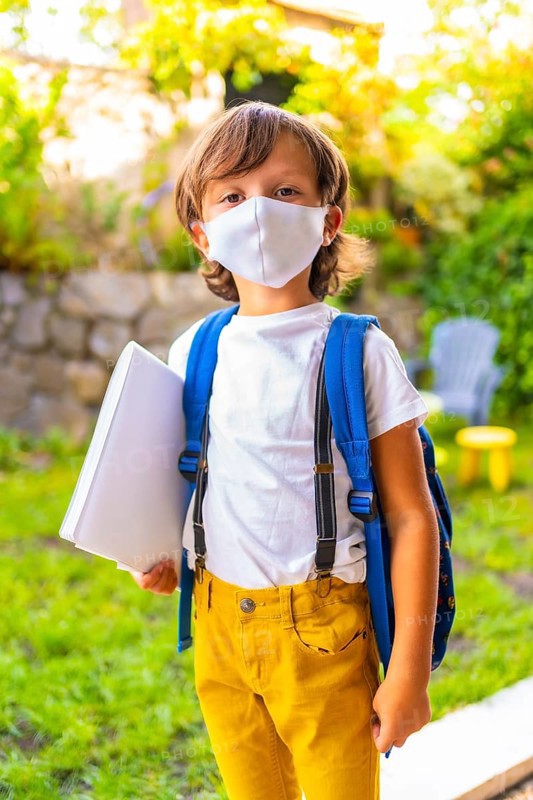 Caucasian child with face mask ready for back to school. New normality