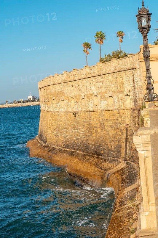 Walls and sea coast of the Baluarte de la Candelaria in the city of Cadiz. Andalusia