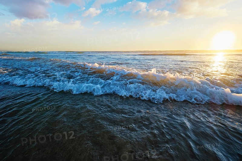 Atlantic ocean sunset with surging waves at Fonte da Telha beach